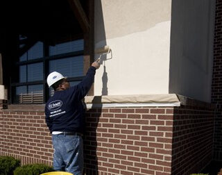US Exterior crew re-coating the exterior of a commercial building