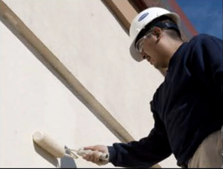 US Exterior crew painting the exterior of a commercial building.