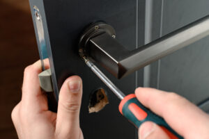 Installation of a door handle on interior doors, carpentry work with doors, metal door handle.